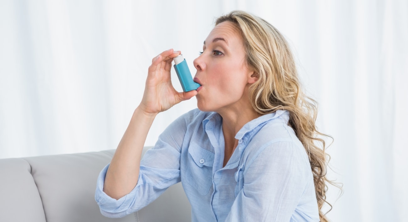 woman with asthma inhaler for relief
